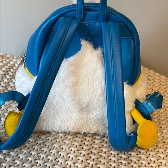 donald duck mini backpack by loungefly 90th Anniversary Lenticular and printed details Coordinating inside lining Dimensions Loungefly Donald and Daisy Mini